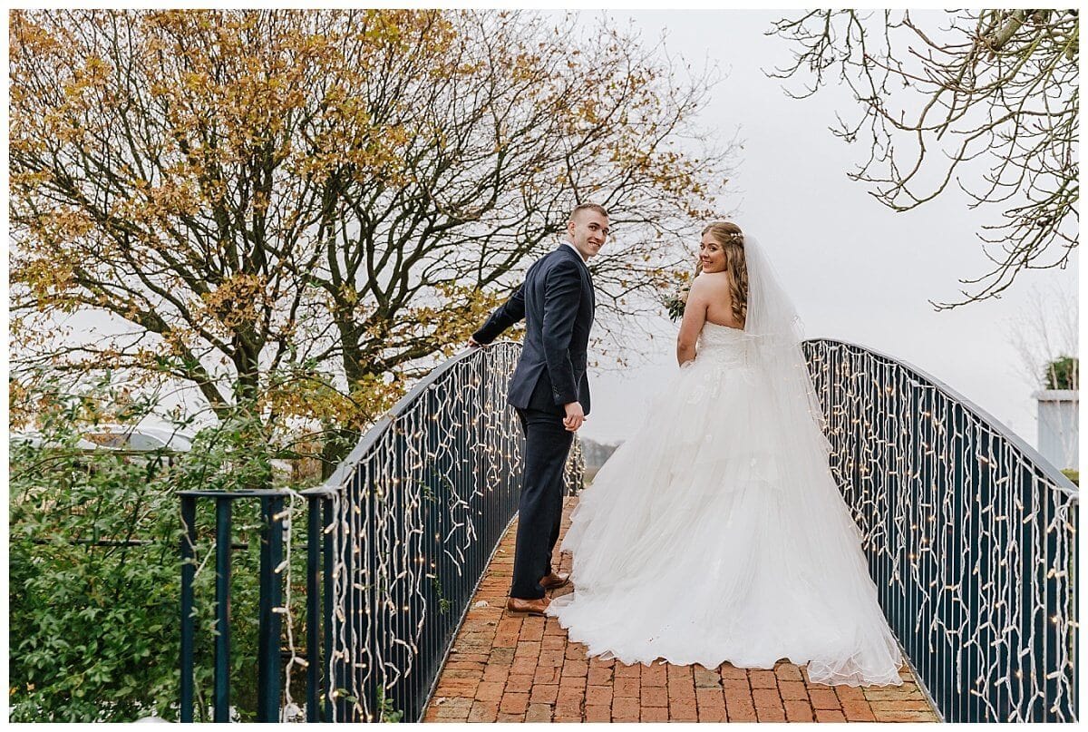 Bride and Groom on the Bridge at Bassmead Manor Barns